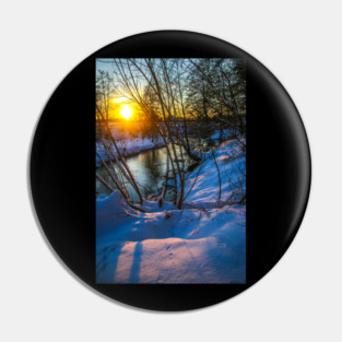 Snow falling on a river with snowy banks Pin