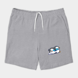 Cute penguin sleeping with fish Shorts