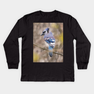 Blue Jay with brown and grey blurred background and green blurred leaves Kids Long Sleeve T-Shirt
