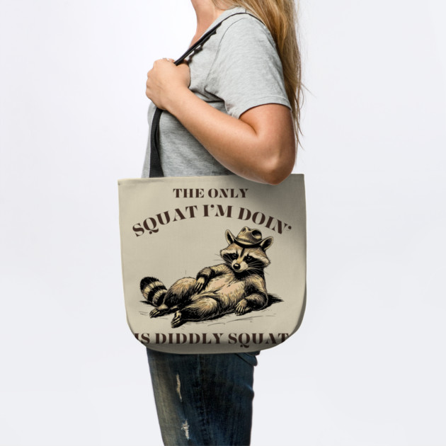 The Only Squat I’m Doin’ Is Diddly Squat - Funny Cowboy Raccoon by Creatifly Graphic Tees