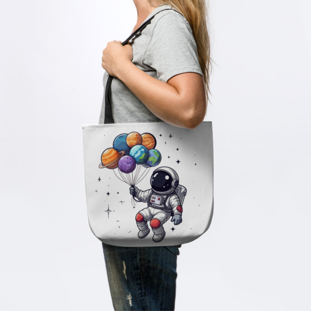 Astronaut Holding Planets by Creatifly Graphic Tees