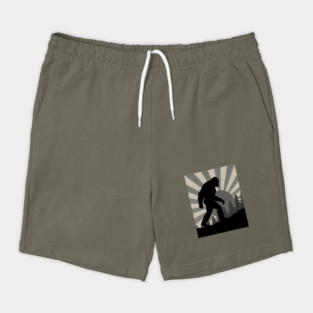 Retro Bigfoot Walking Silhouette in Vintage Grayscale Forest Scene  📝 Description: Shorts