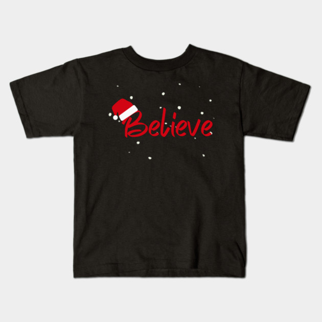 Believe Christmas Santa Hat Snowy Holiday Lettering Kids T-Shirt by Creatifly Graphic Tees