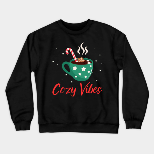 Cozy Vibes Hot Chocolate Mug with Marshmallows on Snowy Black Crewneck Sweatshirt by Creatifly Graphic Tees