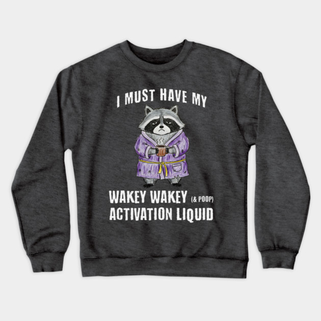 Grumpy Raccoon I Must Have My Wakey Wakey (& poop) Activation Liquid Crewneck Sweatshirt by Luxinda